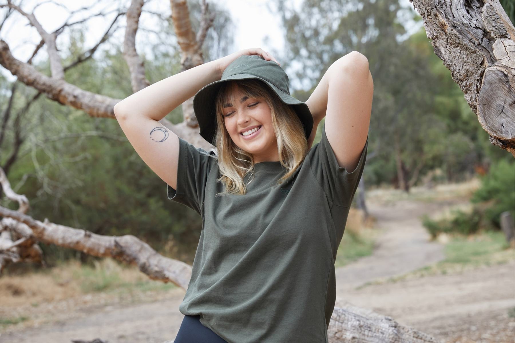 Model in nature smiling